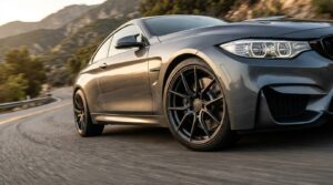 High-performance SSW alloy wheels on a grey sports car driving through a mountain curve, illustrating improved car handling and reduced unsprung weight.